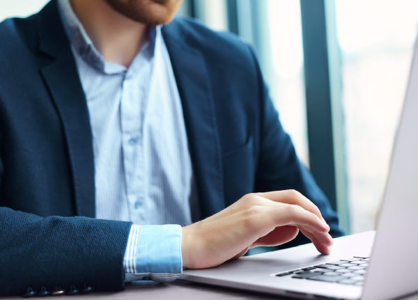 young-man-working-with-laptop-man-s-hands-notebook-computer-business-person-workplace 1