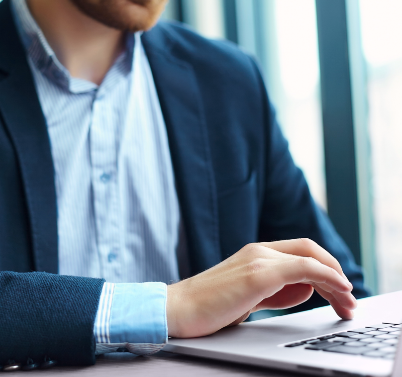 young-man-working-with-laptop-man-s-hands-notebook-computer-business-person-workplace 1